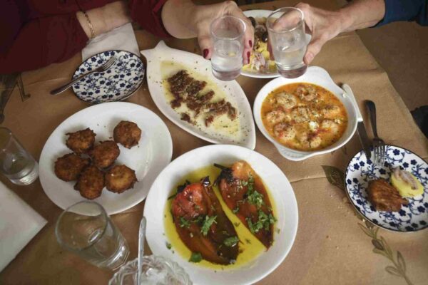 a table with plates of food and glasses