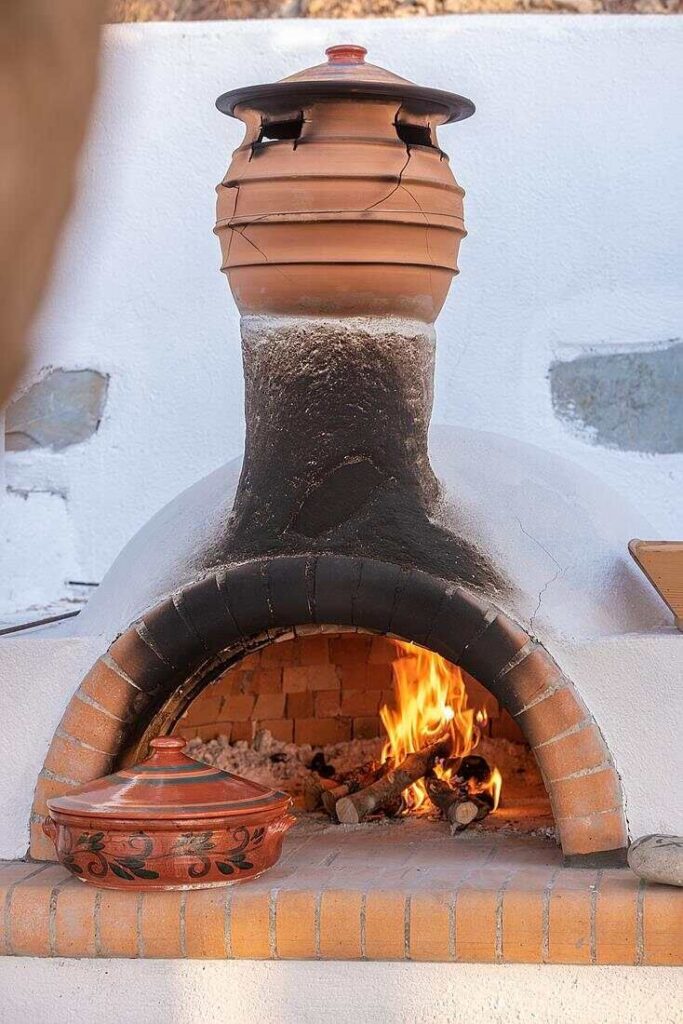 Fire burning brightly in a traditional wood oven.