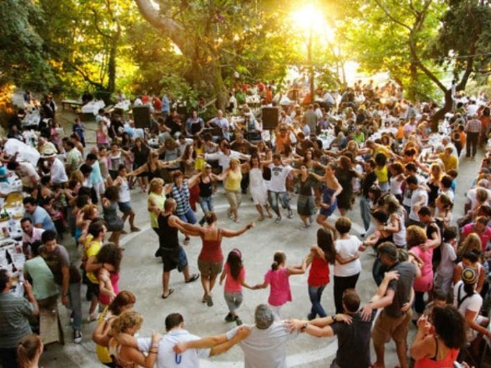 people dancing in circle at Flavors of August at Isioma Karies