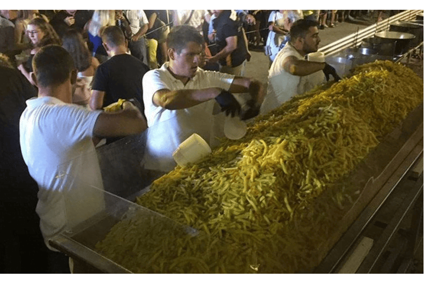 men unpeeling poatotes at Naxos fries over 600 kilos of potatoes to break Guinness Record!
