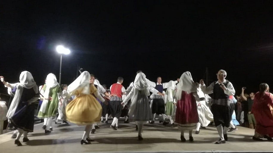 Festival for the Raising of the Holy Cross church with people people dancing by night at Paros, Ageria, Greece