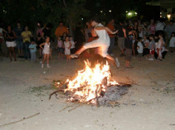 boy jumping a fire at festival of St. John of Klidonas in Aliki, Paros.