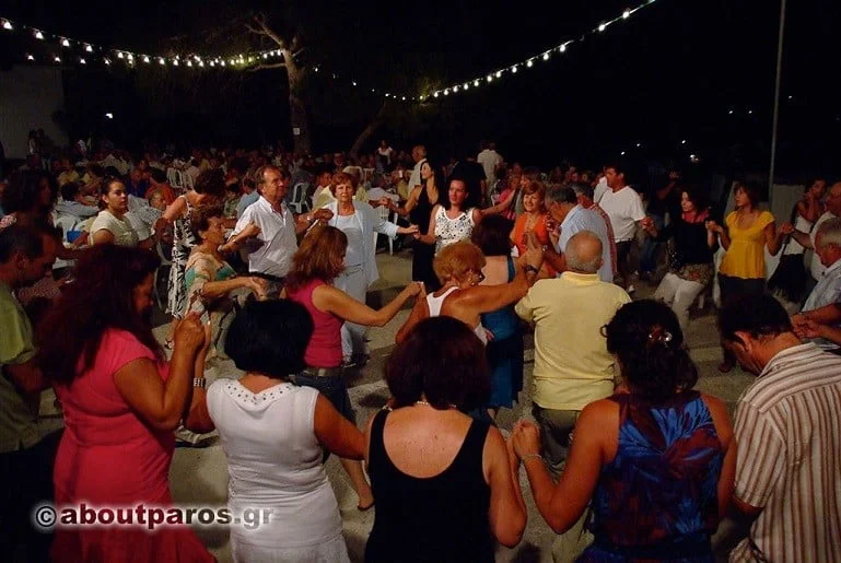 People dancing on circle at Festival of the Transfiguration of Jesus at Paros, Aliki, Greece by night