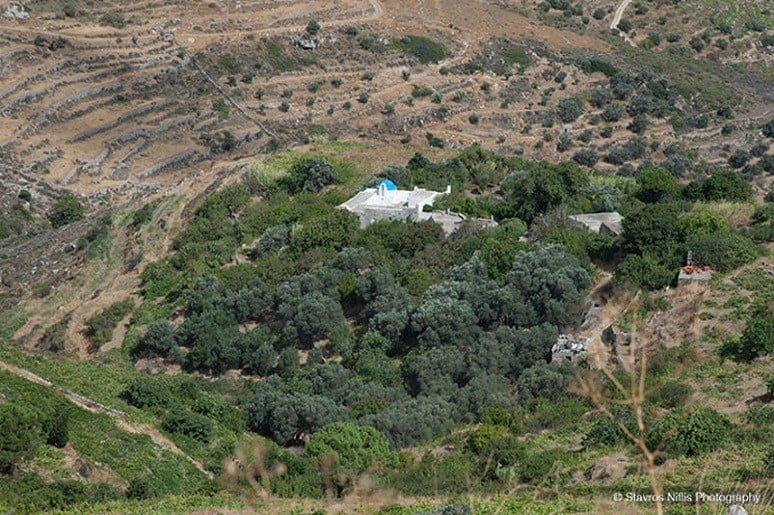 Church of St. John of Kaparos commemorate festival of her birth at Paros, Greece surrounded by trees and hills