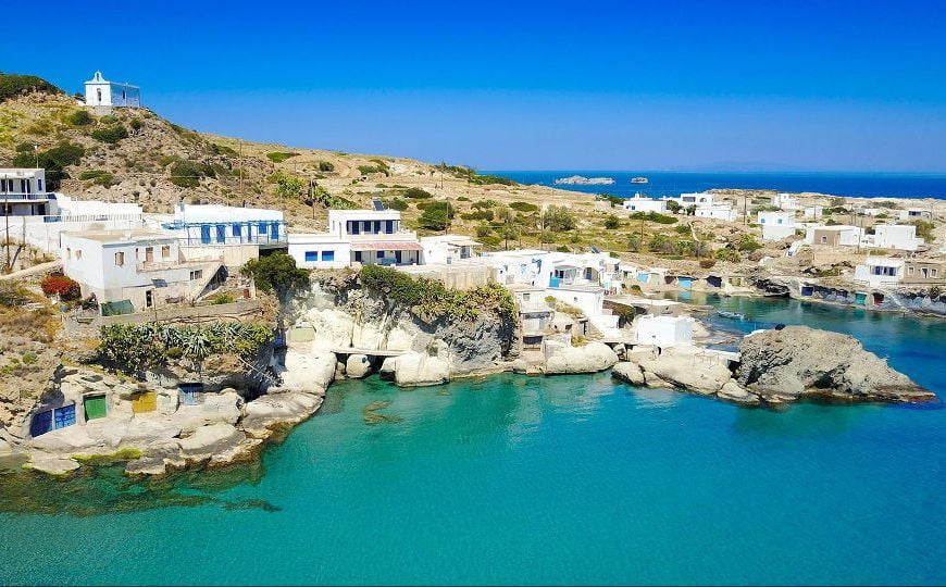 port with houses and The Telegraph: 14 Small Greek Islands to Visit after Lockdown|