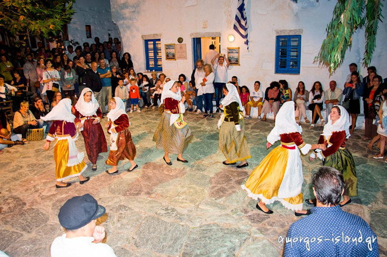 women dressed with folklore cloths dancing at the Pasteli Festival, Amorgos, Chora, Greece