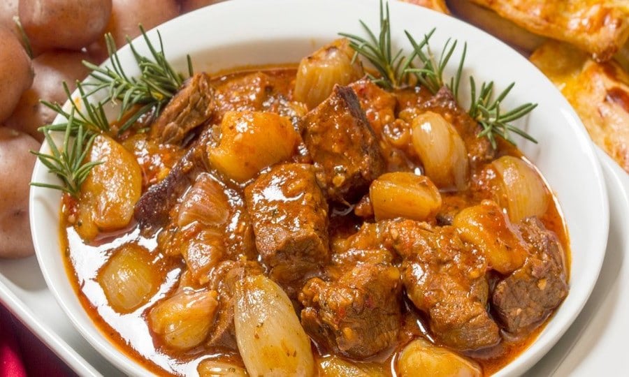 plate with ‘stifado’ means cooking meat with onions in tomato sauce and is the best food in Greece|