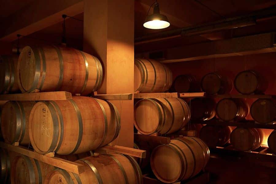 wine wood barrels on top of each other at Boutari Crete Winery cellar