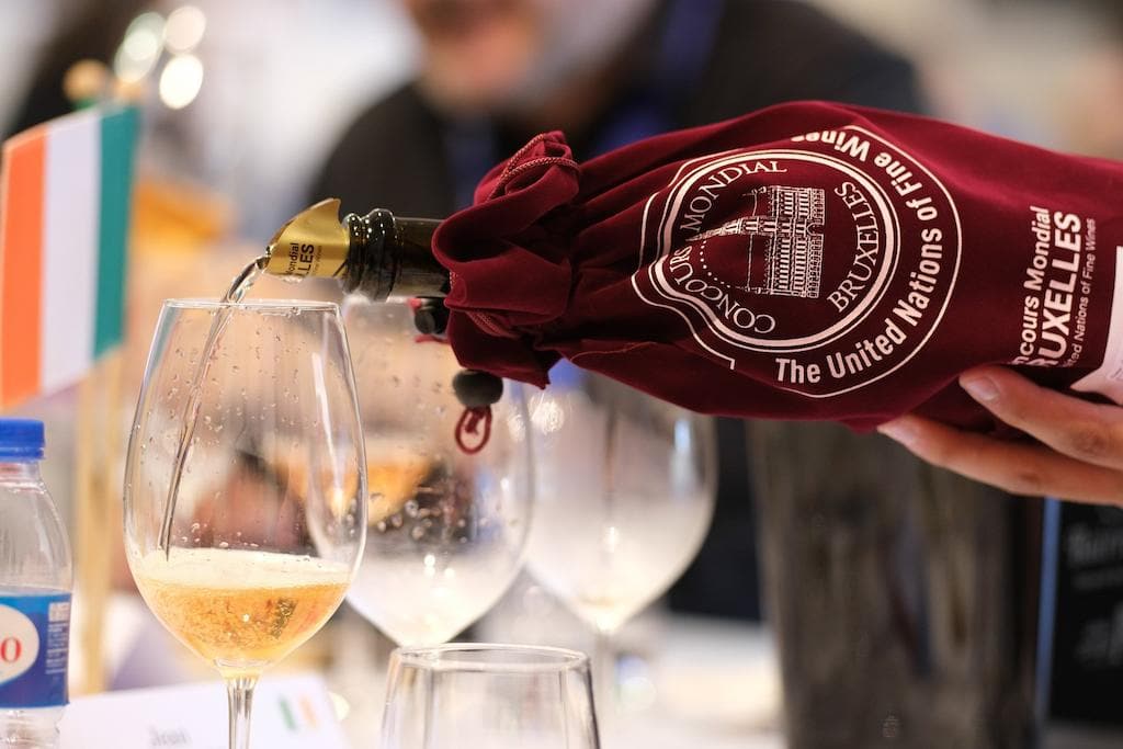 close-up of a man pouring wine into glass|