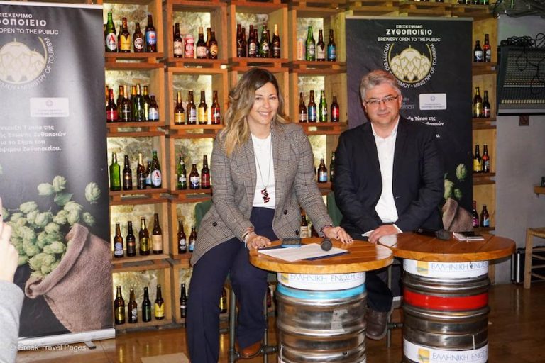 a couple smiling at the camera||a woman speaks at a microphone|shelves with beer bottles|a man speaks at a microphone|POSTER greek visited breweries