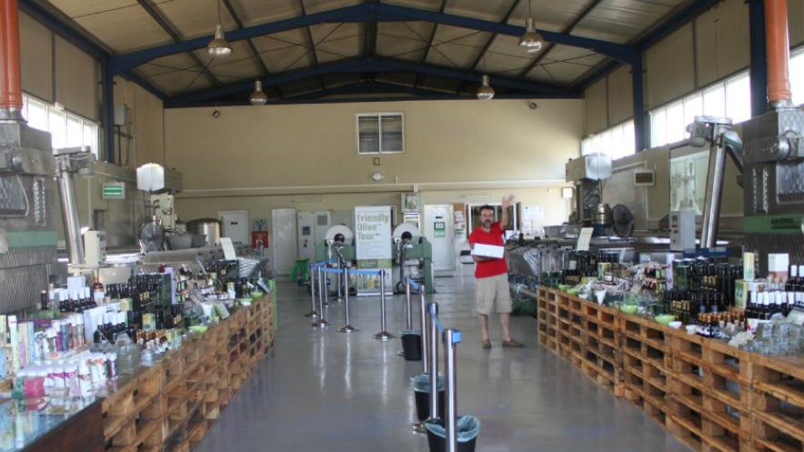 corridor of 'Vassilakis Estate' olive oil plant with olive oil products on tables on the both sides