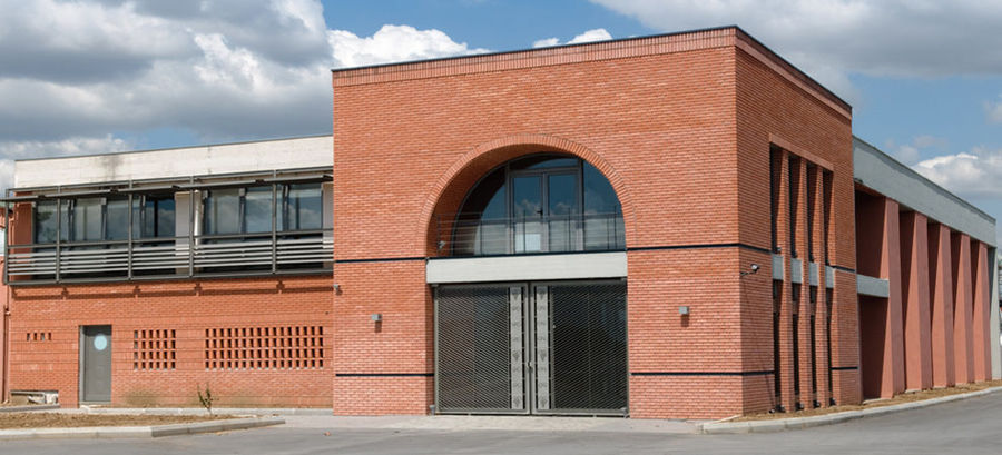 entrance of 'Tsililis' building surrounded by pavement and blue sky in the background