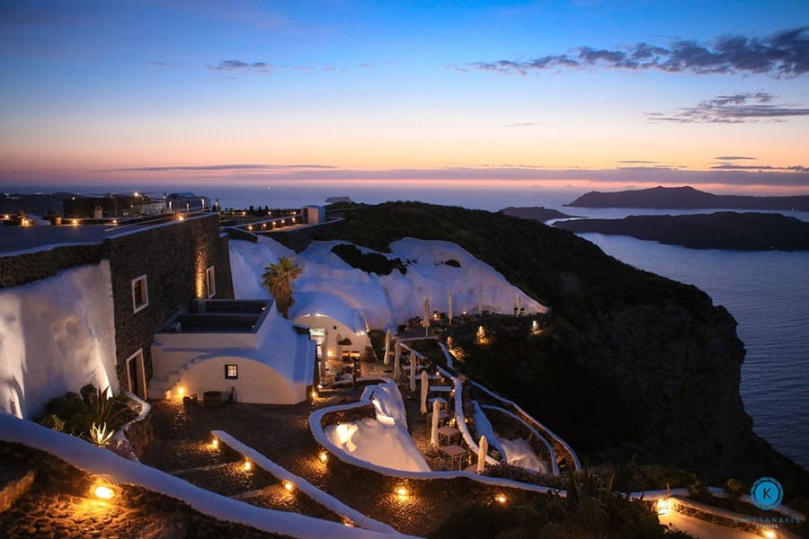 night view of 'Venetsanos Wine Museum' from above with the sea and islets in the background