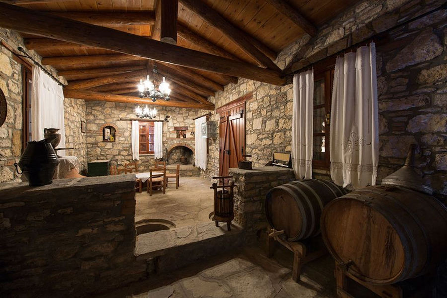 Vakakis Winery stone tasting room with wood ceiling, door and wiindows