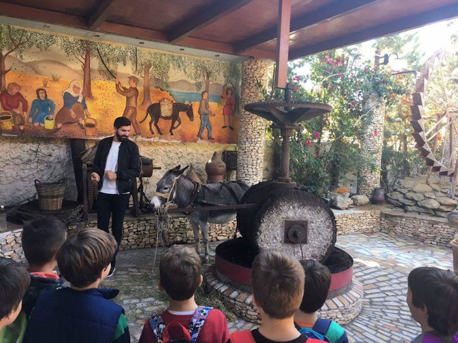 children listening to a man giving a tour at Zahaios winery