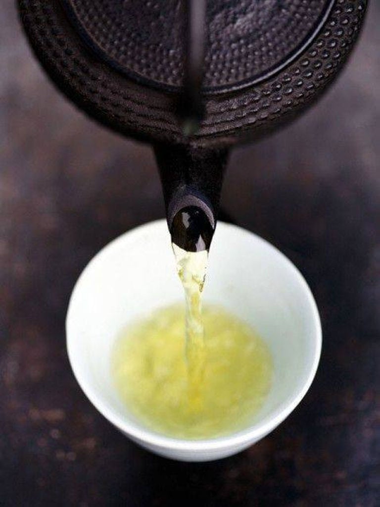 pouring Sideritis tea from kettle into a cup at 'Olympus Herbs'