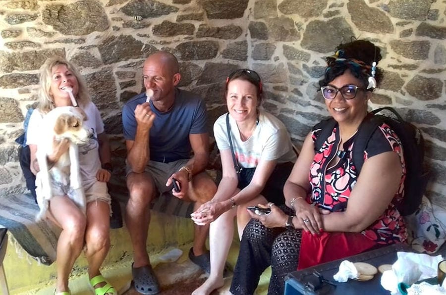 women and a man tourists tasting honey and smiling happily at the camera at 'Melissavet'