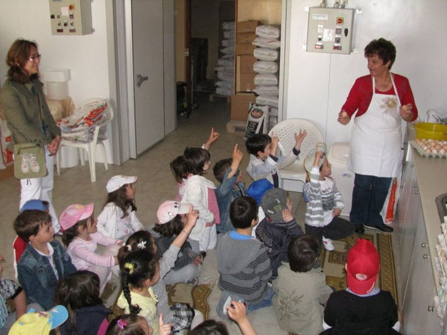 children listening to a woman giving a tour at Thracian Pasta workshop