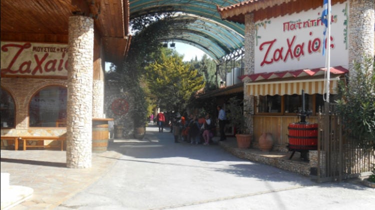 tourists waiting at entrance with stone column of Zahaios winery