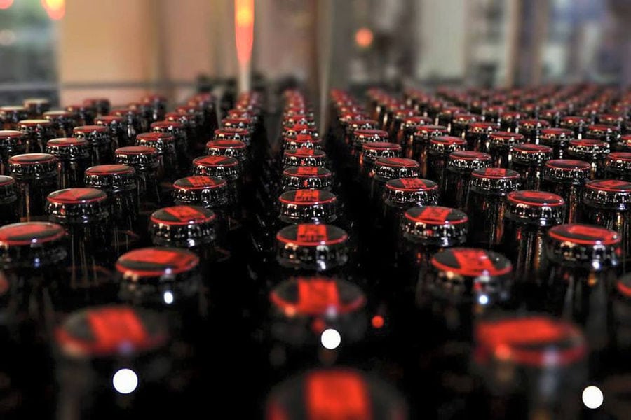Close-up of a view of bottles at beer packaging machine at Elis Brewery plant