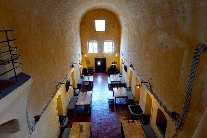 high ceiling room with long wooden tables and benches at 'Venetsanos Wine Museum' from above