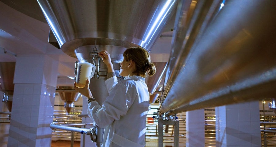 woman collecting sample from the beer tank at 'Vergina Beer' plant
