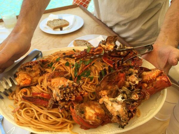 Close-up of plate with Greek astakomakaronada means cooked spaghetti and lobster in tomato sauce