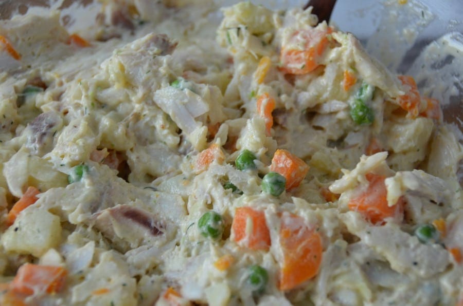 Close-up of Greek ‘Athenian salad fish mayonnaise’ with boiled fish, herbs, carrots and potatoes, capers, pickled gherkins and mayonnaise