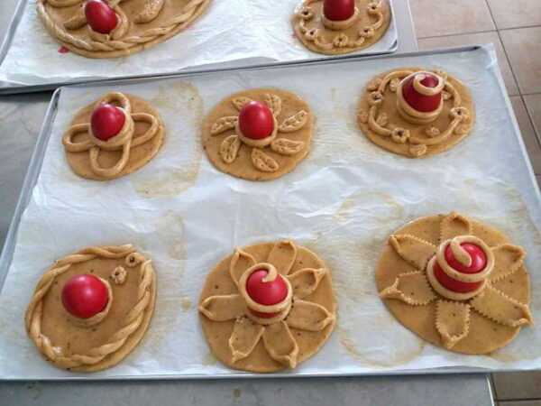 Close-up of avgoules means Greek Easter eggs sweet rolls on bakery pan|