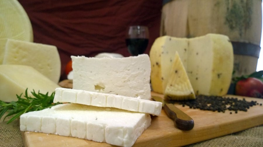 pieces of 'Flegga Creamery' 'feta' and 'graviera' cheeses on wood plateau