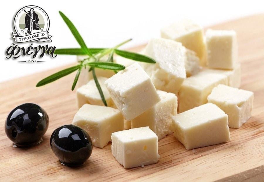 pieces of 'Flegga Creamery' 'feta' cheese and two black olives on wood plateau