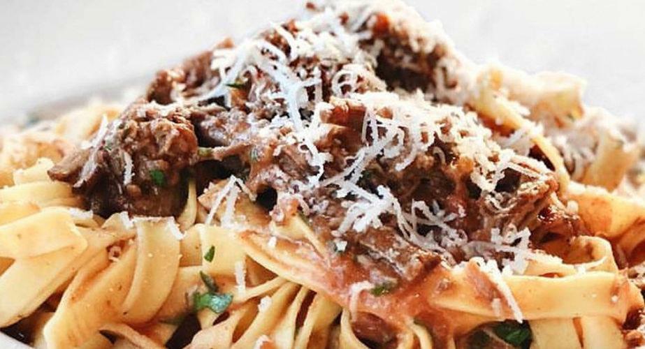 Close-up of Greek ‘Giofkades’ means lasagna pasta cooked with pieces of meet and tomatoes sauce