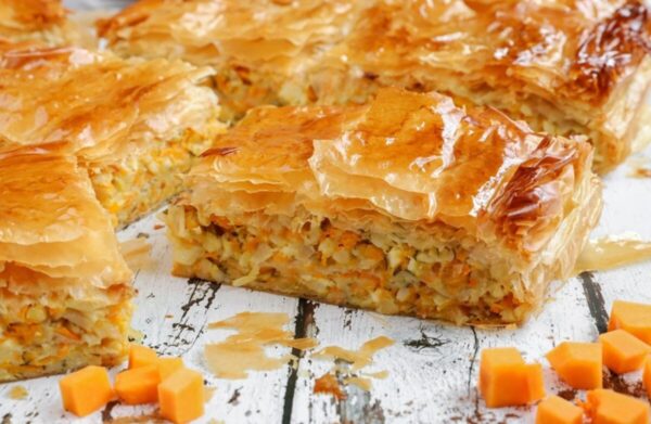 close-up of baked pan with pieces of ‘Kolokythopita’ means zucchini pie|