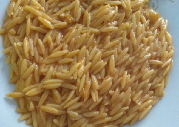 Close-up of Greek ‘Kritharaki’ food means orzo pasta cooked with tomatoes sauce|