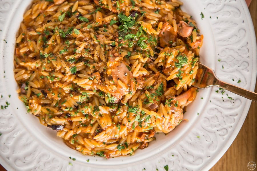 Close-up of Greek ‘Kritharaki’ food means orzo pasta cooked with tomatoes sauce and peces of meat