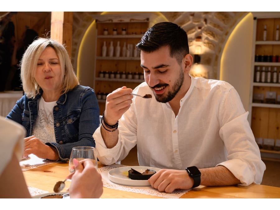 Two individuals relish their desserts, their faces lit up with pure joy and fascination. With each bite, their genuine interest and happiness shine through, creating a delightful moment of culinary delight.