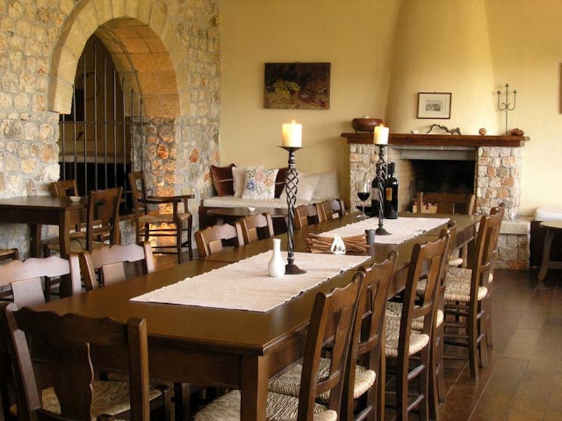 Lafkiotis Winery tasing room with wood tables and chairs and fireplace