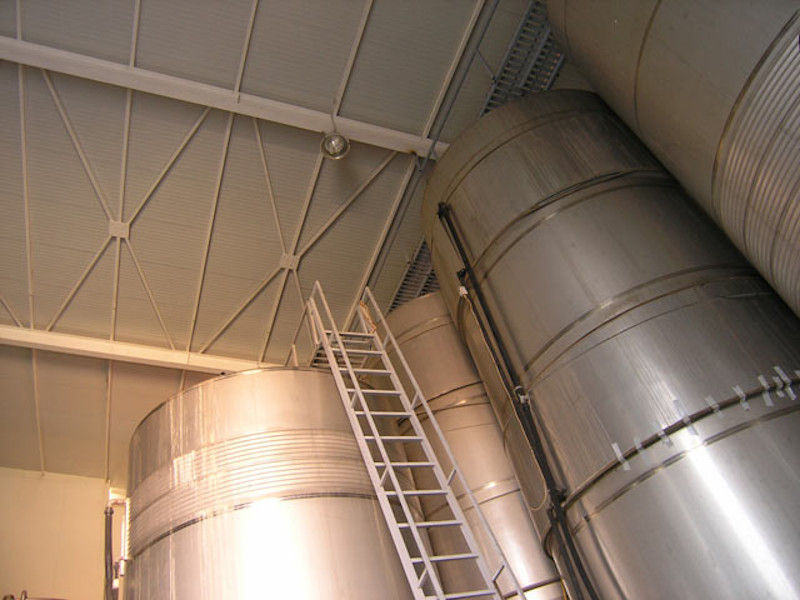 view starting at the base to on the top of aluminum wine storage tanks at Lafkiotis Winery plant