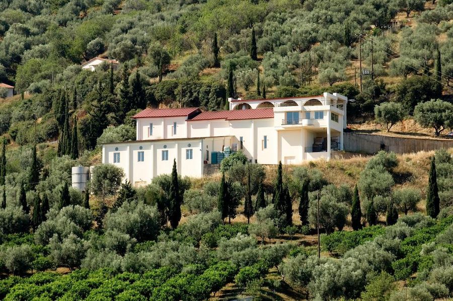 Rouvalis Winery building surrounded by trees and vines