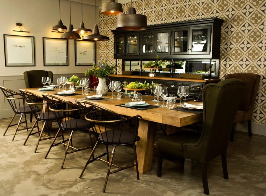 Semeli Estate tasting room with a wood tables and chairs and glasses