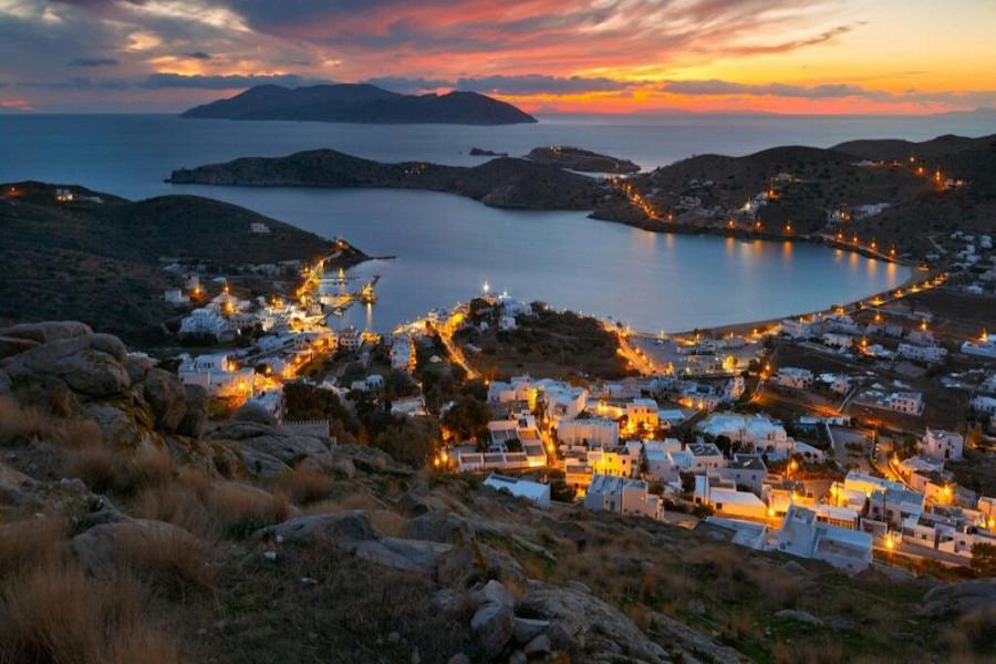 Skinos from above with illuminated houses and the sea by night