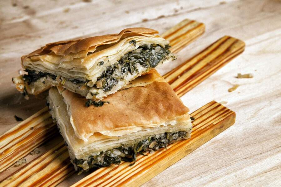 two pieces of ‘Hortopita’ is a combination of spinach and feta cheese tucked in layers of filo dough on the top of each others