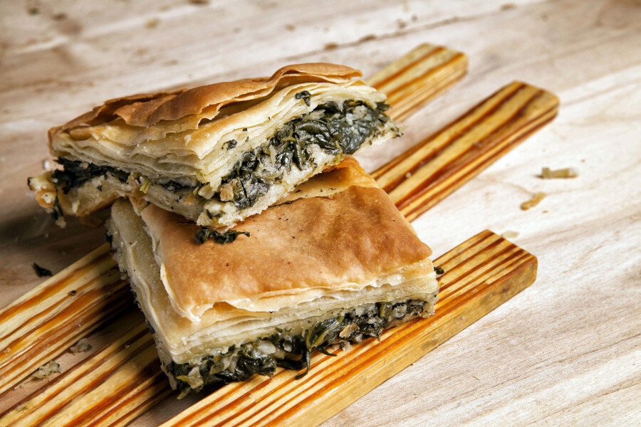 pieces of Greek spanakopita, pita using pastry crust or filo baked in the oven filling with spinach 