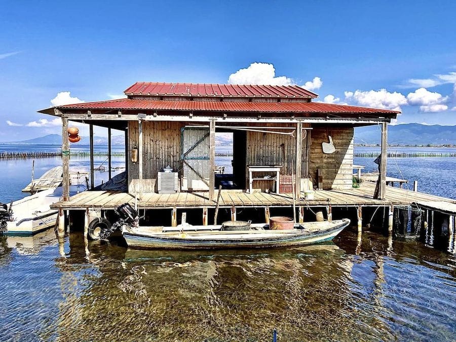 Stefanos Kaneletis’ fishing cottage on the sea with boat on the water