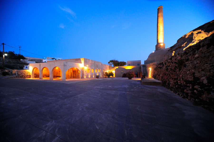 side of the building of 'Tomato Industrial Museum' and the tall chimney in the evening