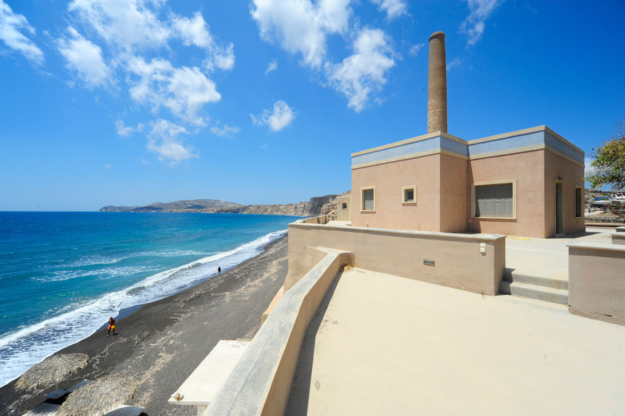 side of the building of 'Tomato Industrial Museum' above the beach