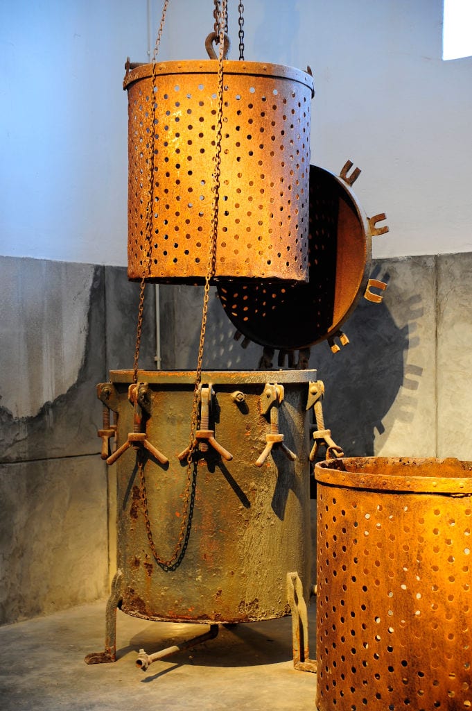 large rusty tubes with holes at 'Tomato Industrial Museum'