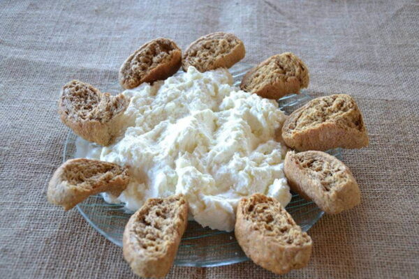 Close-up of Greek ‘Xigalo of Sitia’ spread cheese surrounded by small dry breads