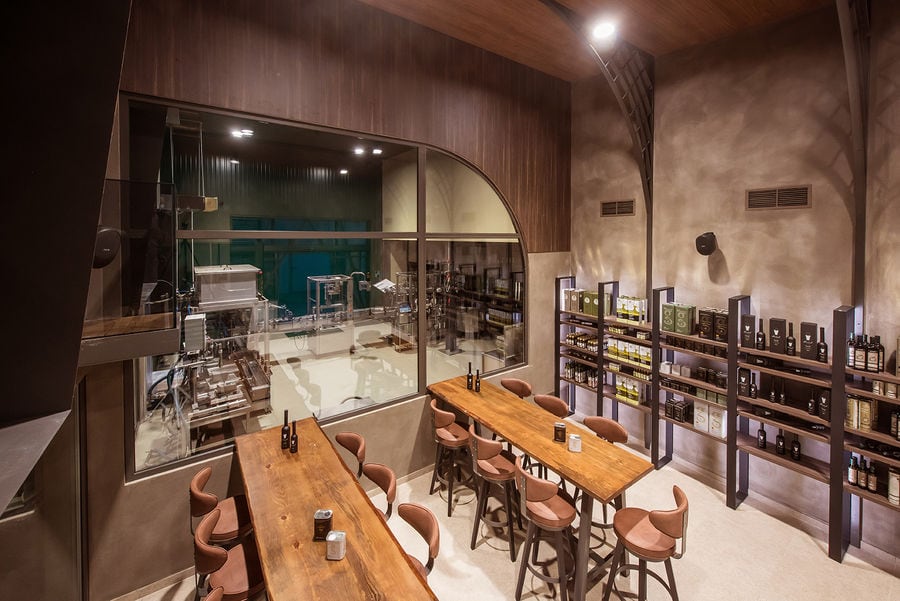 Savouidakis' Olive Oil Tasting Area, with 2 large tables and chairs.