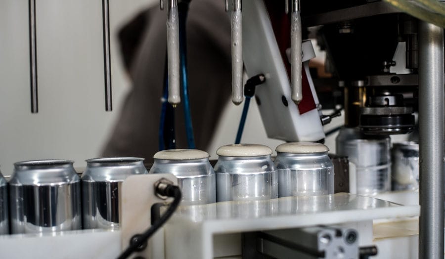 Production machine that fills the beer cans